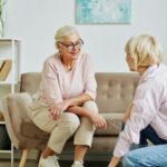 young woman setting up smart home for senior mother